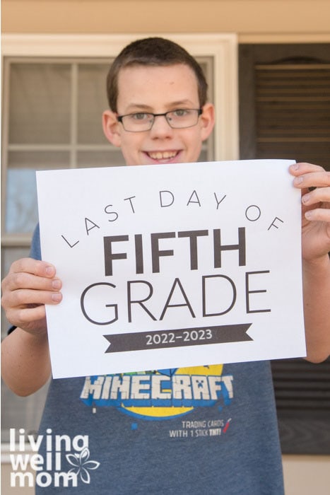 boy holding sign on the last day of 5th grade