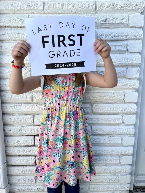 girl holding up printable last day of school sign
