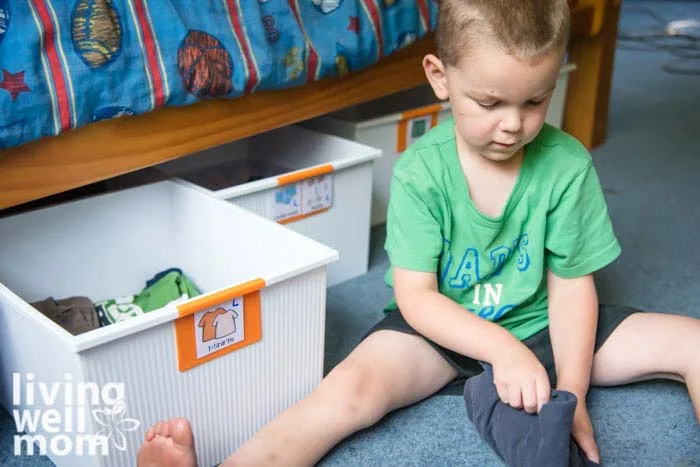 boy folding a shirt