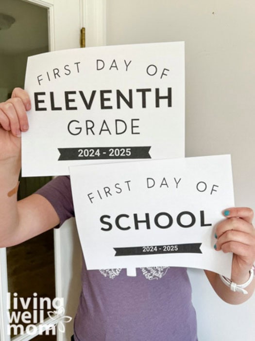 kid holding up two back to school signs