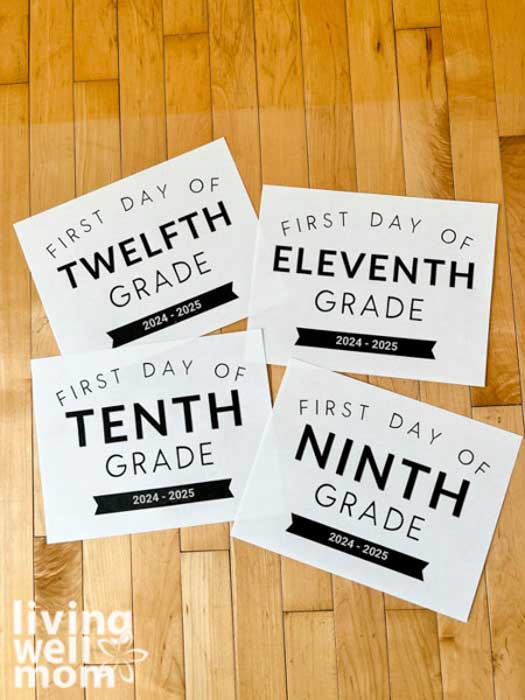 free printable first day of school signs on a table