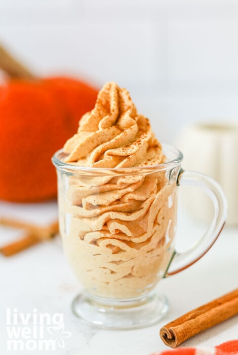 Glass of pumpkin spiced whip topping with cinnamon. 