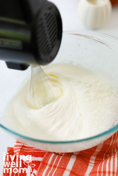 Whipping heavy cream in a stand mixer.