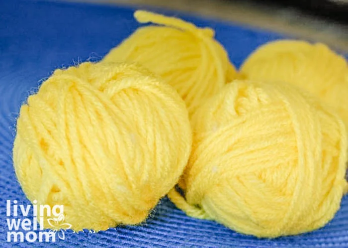 four yellow yarn balls 