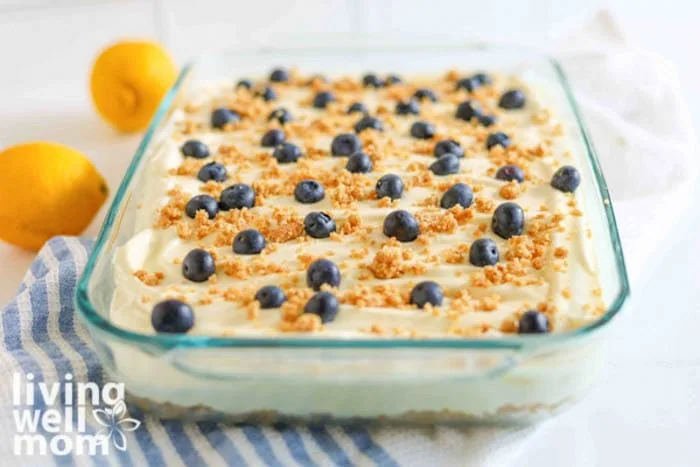 creamy, lemon blueberry bars in a glass pan