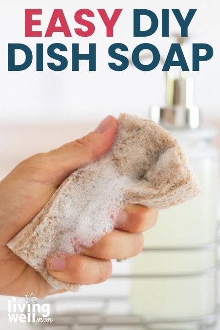 Woman holding a sponge filled with suds from a homemade dish soap recipe.