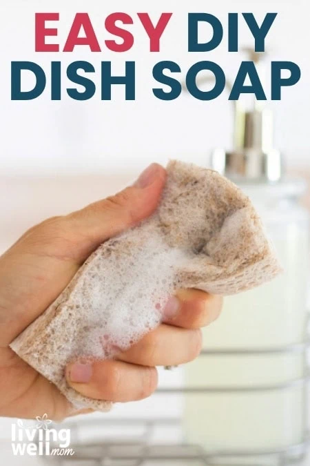 Woman holding a sponge filled with suds from a homemade dish soap recipe.
