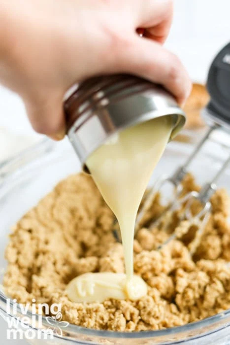 pouring sweetened condensed milk from a can