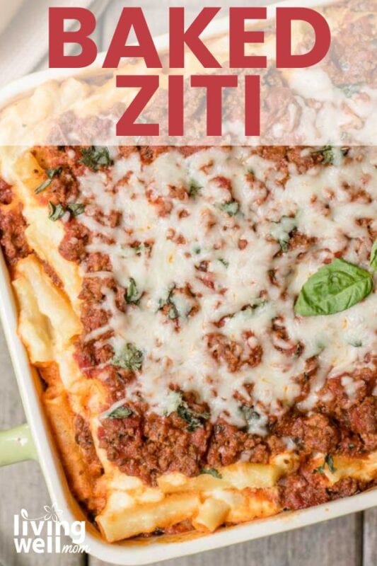 Close up of homemade baked ziti topped with fresh basil.