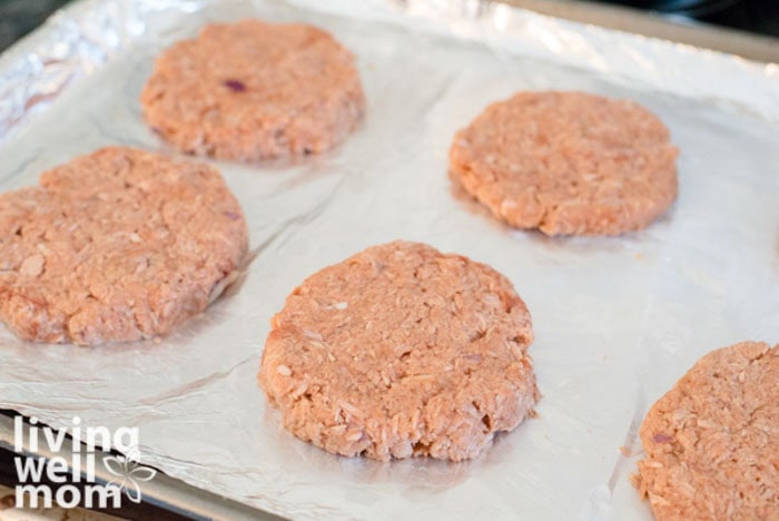 formed fish patties on a lined baking sheet