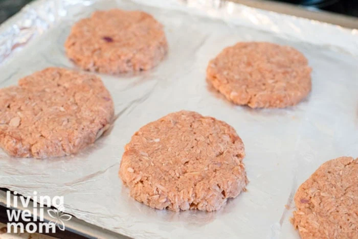 formed fish patties on a lined baking sheet