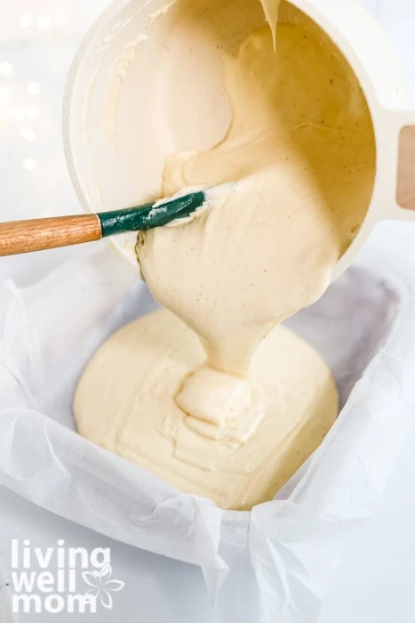 Eggnog fudge poured into a parchment-lined baking pan.