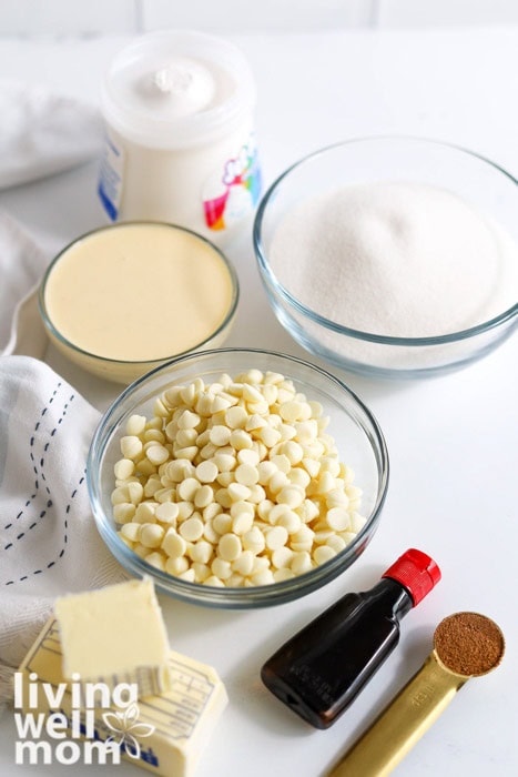 Bowl of ingredients for eggnog fudge including butter, sugar, eggnog, and white chocolate chips.