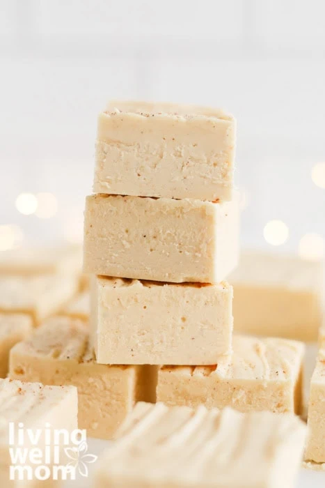 Eggnog fudge cut into neat squares and stacked.