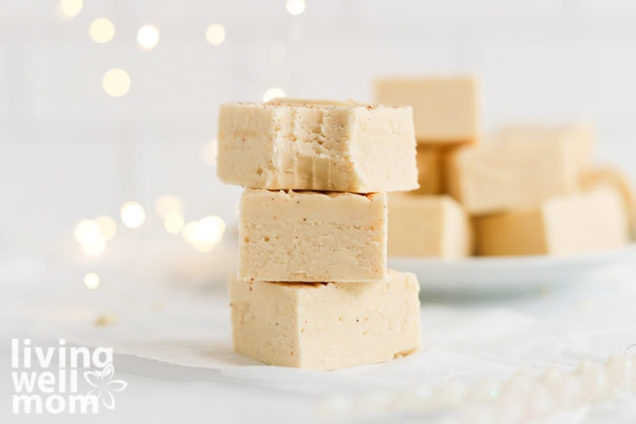 Stack of eggnog fudge pieces showing the soft, creamy interior.