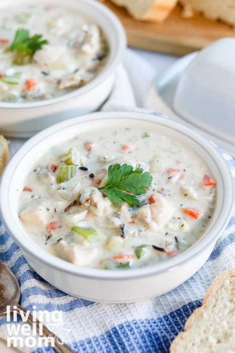 Overhead view of slow cooker creamy wild rice and chicken soup in a white bowl