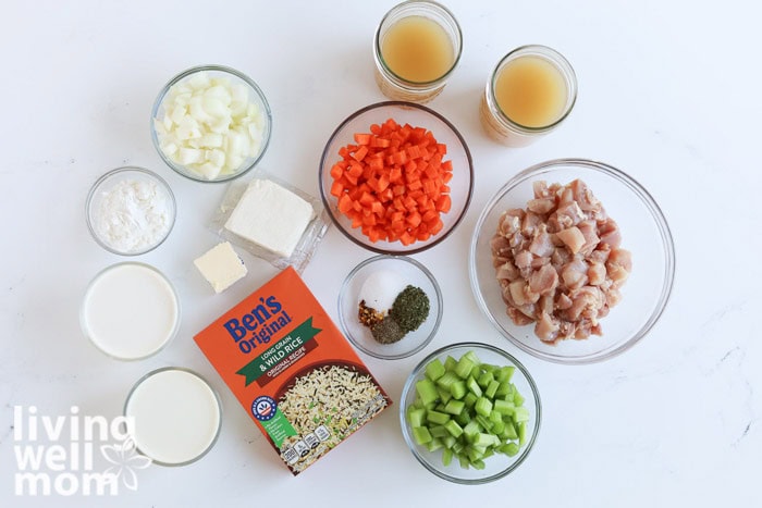 Ingredients for creamy chicken and wild rice soup laid out on a kitchen counter