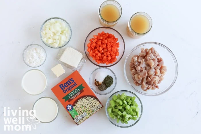 Ingredients for creamy chicken and wild rice soup laid out on a kitchen counter