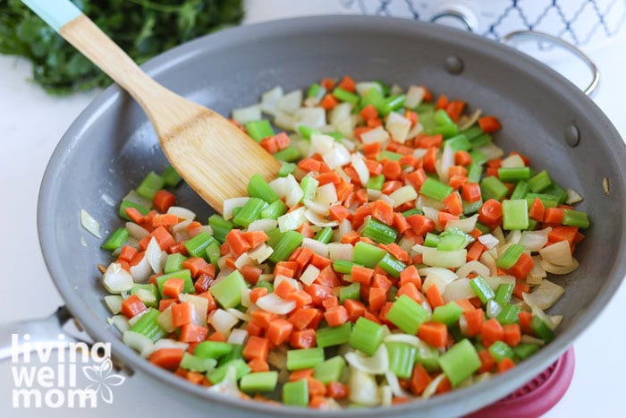 Sautéing onion, carrots, and celery in butter before adding to the crockpot