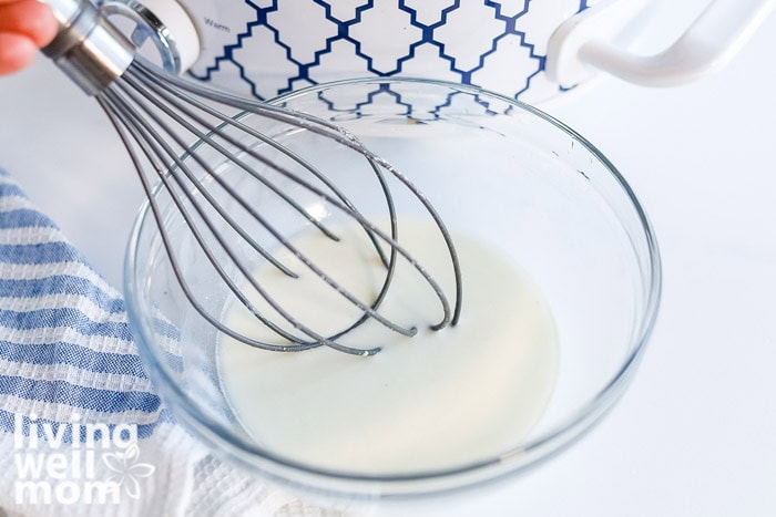 Whisking cornstarch and water together to thicken homemade wild rice soup