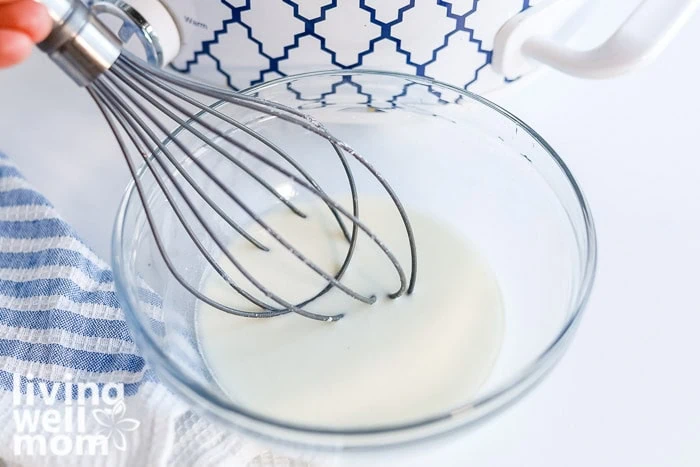 Whisking cornstarch and water together to thicken homemade wild rice soup