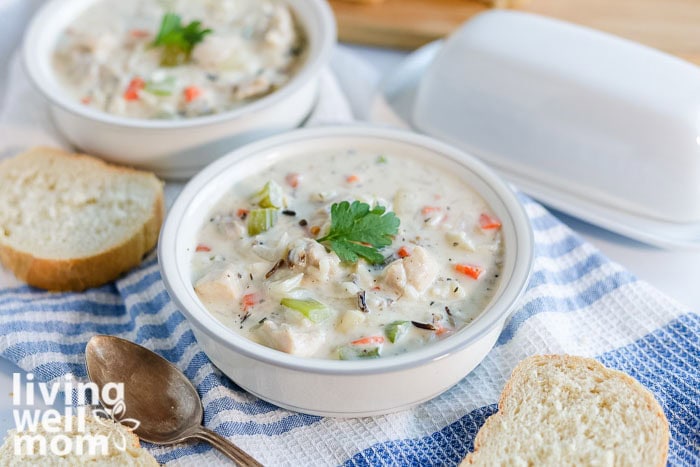 Creamy chicken wild rice soup served with warm bread for dipping