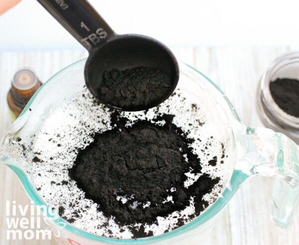 Activated charcoal being sprinkled into soap base