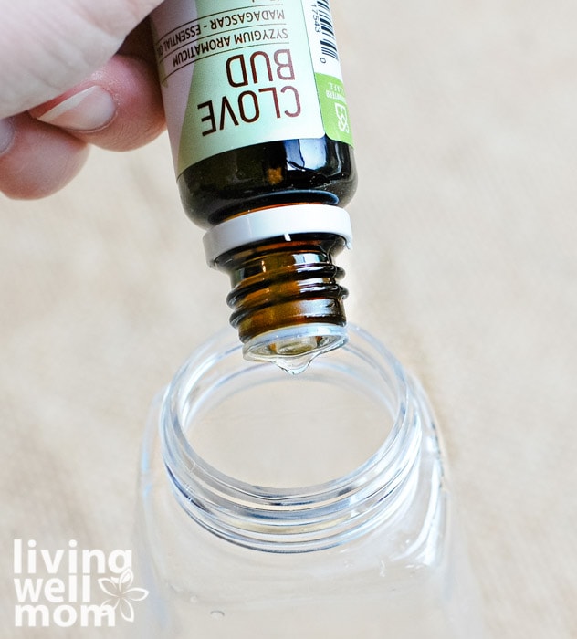 adding clove oil to an empty bottle