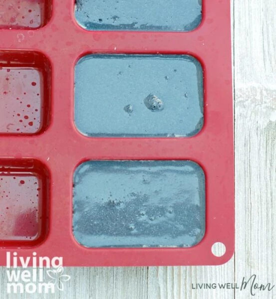 DIY charcoal soap bars drying in a soap mold