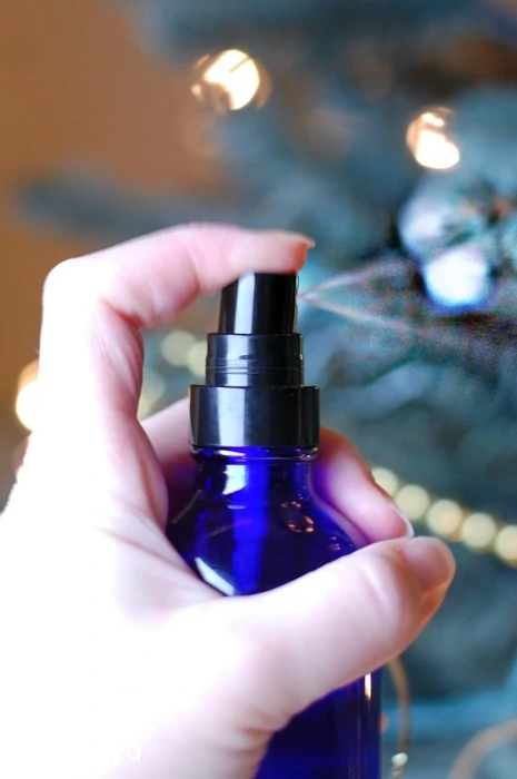 Spraying an aromatherapy room spray during the holidays
