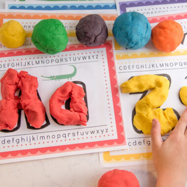 child playing with colorful alphabet playdough mats