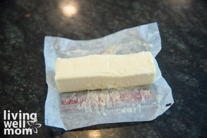 A soft rectangle of butter on a wax paper wrapper. 