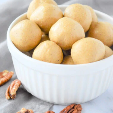 Bowl of spiced almond butter energy bites with pecans