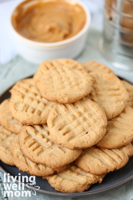 Pile of gluten free peanut butter cookies on a plate.