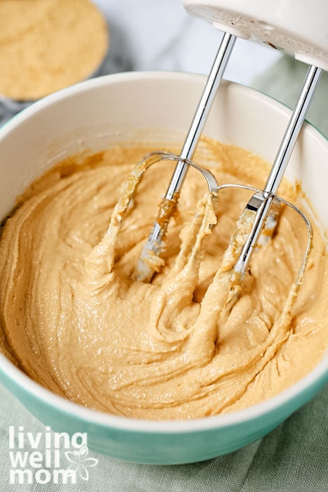 Peanut butter cookie dough being mixed with a mixer
