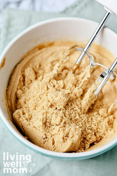 Sugar being added to a gluten free peanut butter dough
