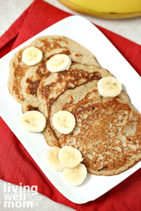banana egg pancakes on a white plate with a red napkin