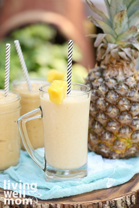 Mango pineapple smoothie divided into 3 cups with straws