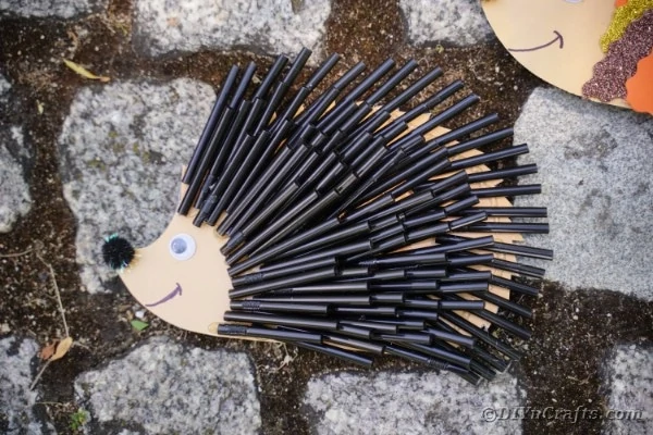 Cute hedgehog made from plastic straws and paper