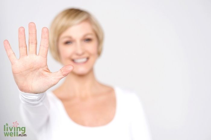 woman holding up 5 fingers
