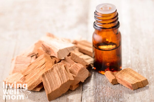 Sandalwood next to a bottle of essential oil