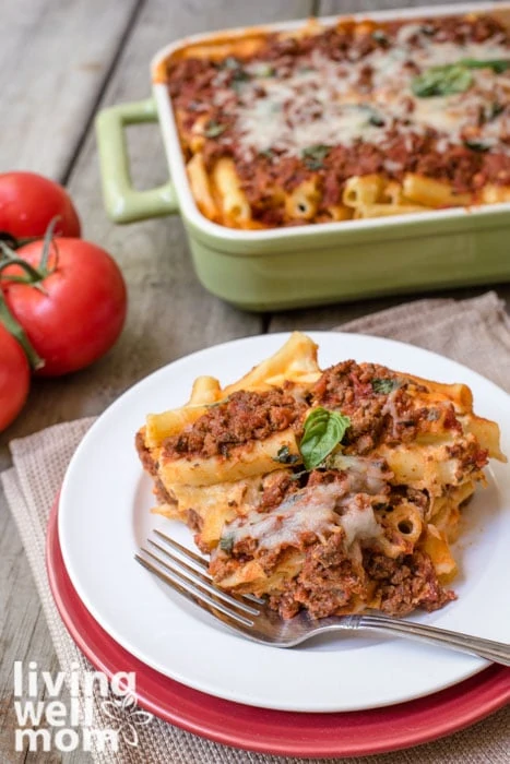 a plate of baked ziti with meat on a plate with a fork