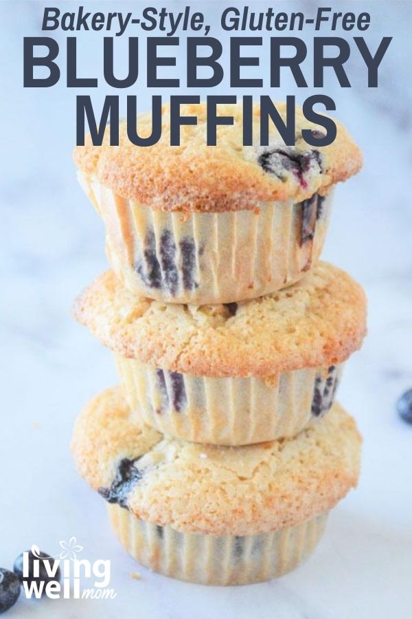 3 gluten-free blueberry muffins stacked on top of each other with a marble background