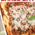 Baked ziti with ricotta in a baking dish topped with fresh basil