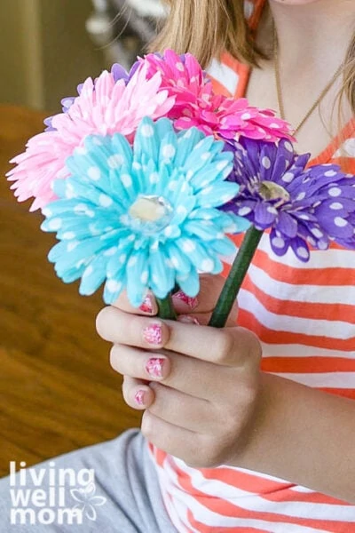 Girl holding a bouquet of colorful flower pens