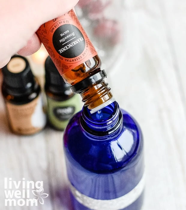 adding Christmas essential oils to diy room spray