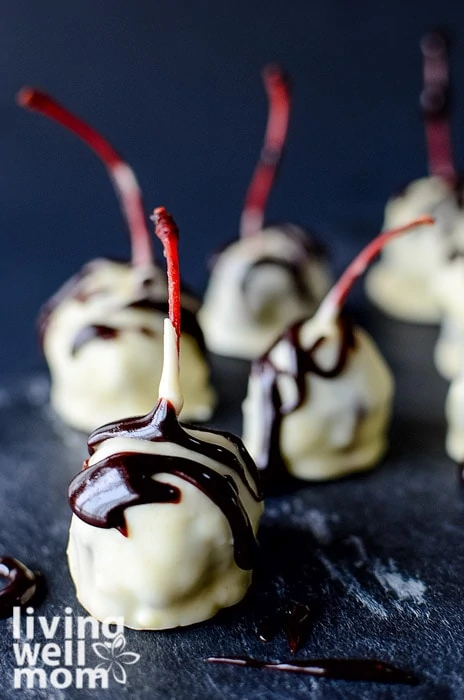 Cherries covered in white chocolate with a dark chocolate drizzle