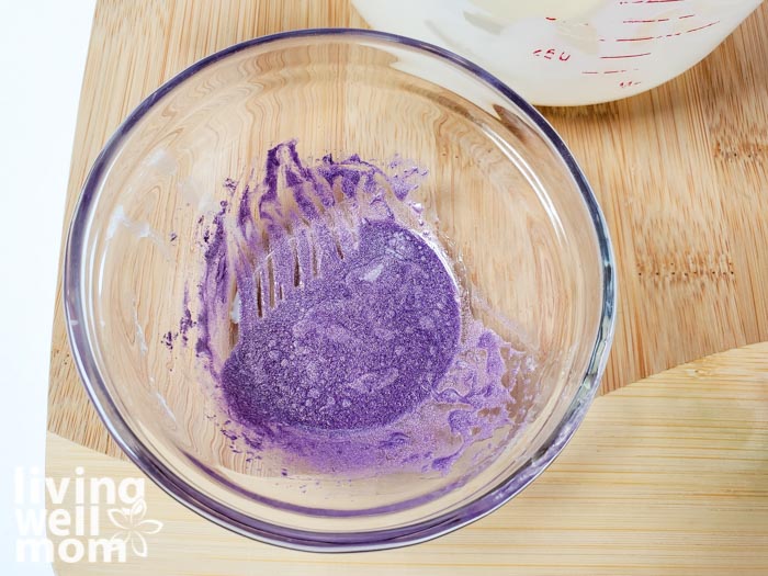 Purple mica power in a bowl to show the vibrant color added into this homemade butter bar recipe. 