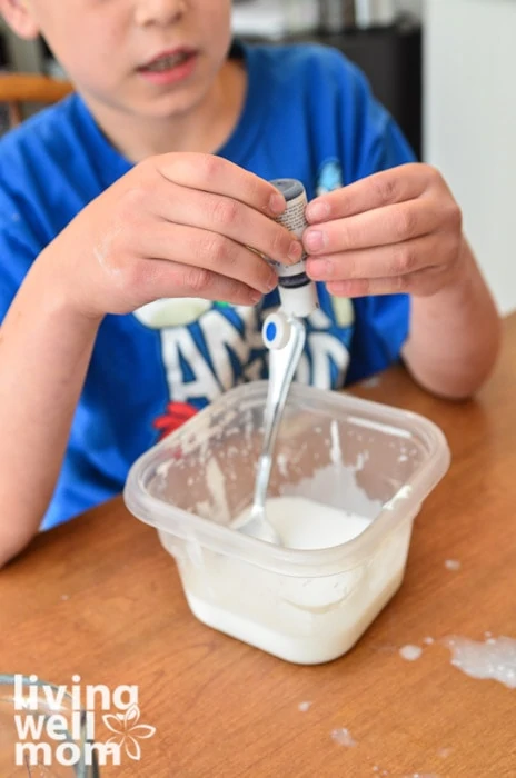 adding blue food coloring to glue mixture
