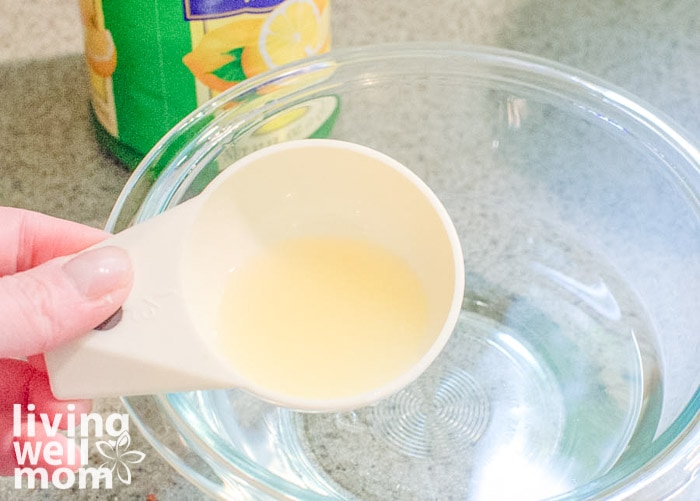 Woman measuring out ingredients to clean the microwave with lemon juice